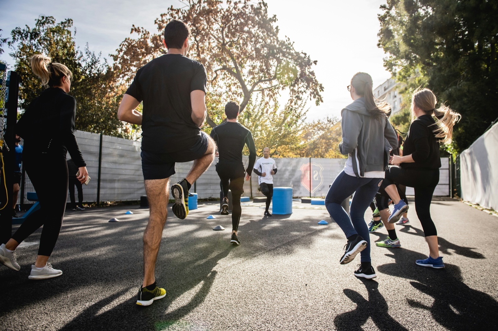 A group running and training outdoors at sunset