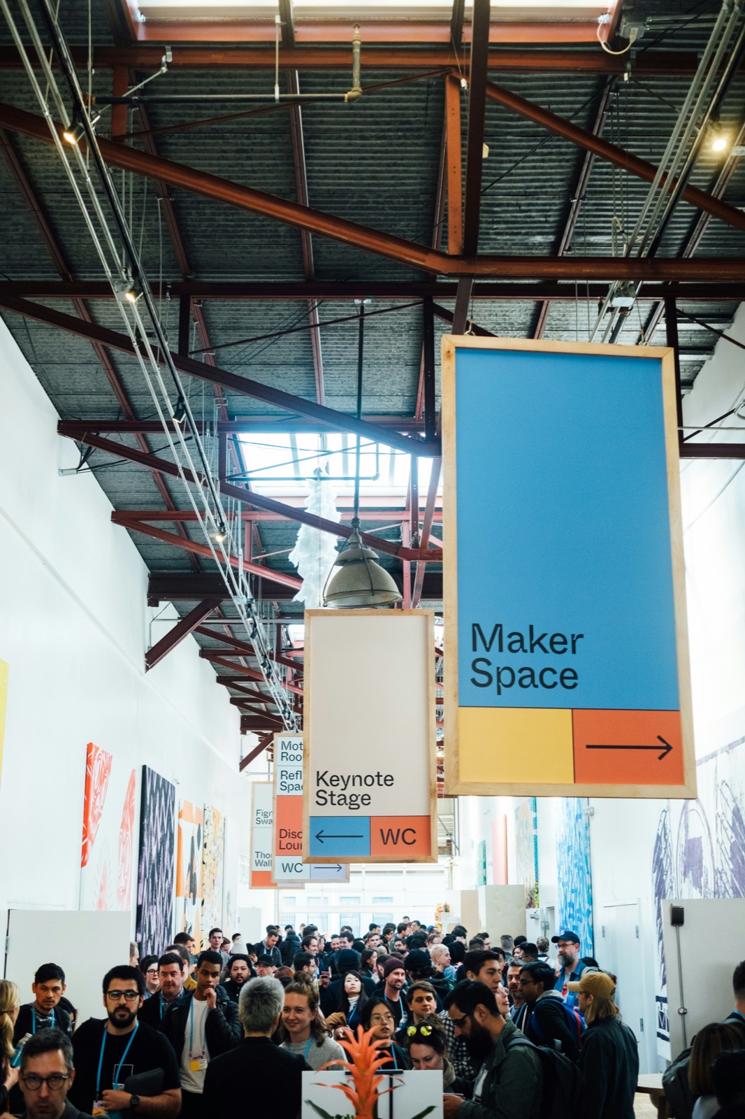 A conference hall with attendees gathered under signage
